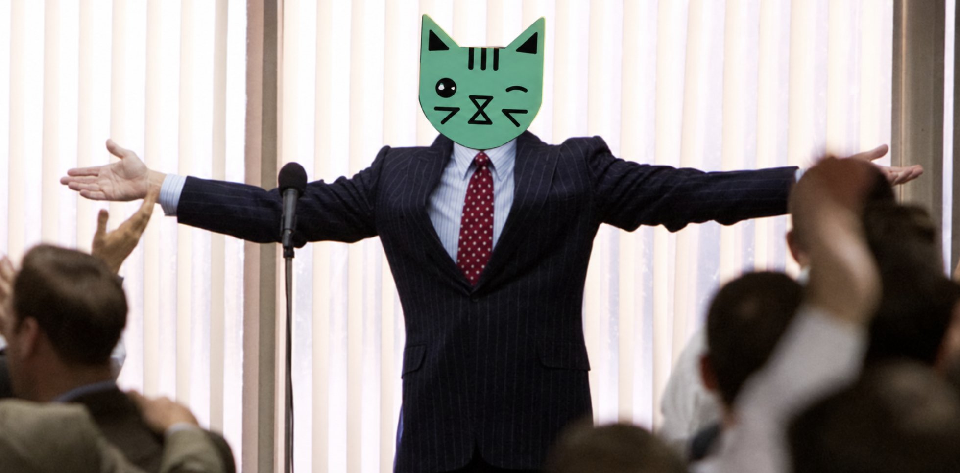 The cat in a pinstripe suit at a podium, arms wide, a crowd cheering in front of him